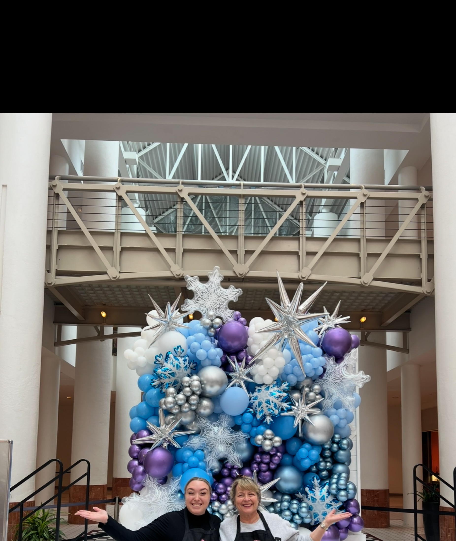 Winter wonderland — silver, blue, and white balloon arch with snowflakes